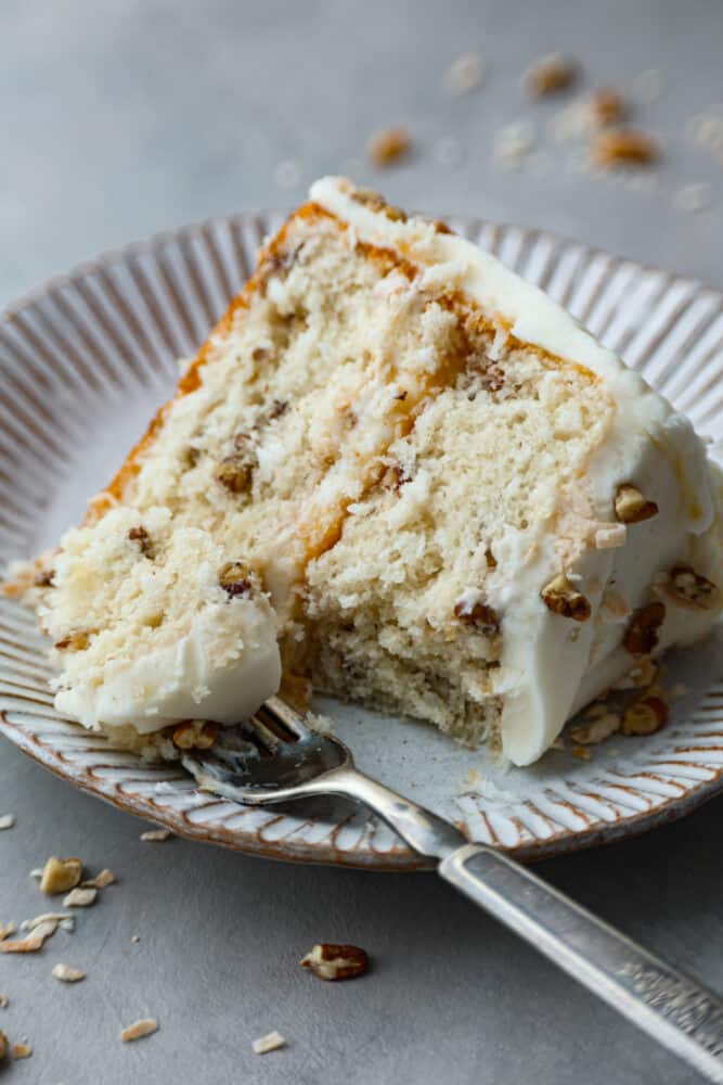 Closeup of a slice of cake. A bite is taken out of it with a fork.