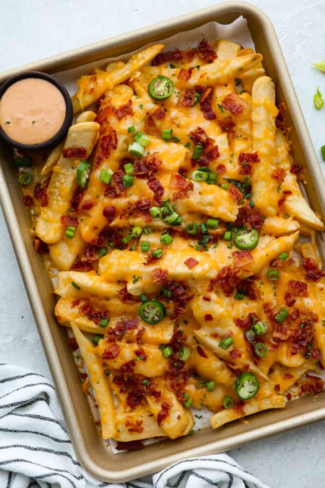Top-down view of loaded fries in a sheet pan.