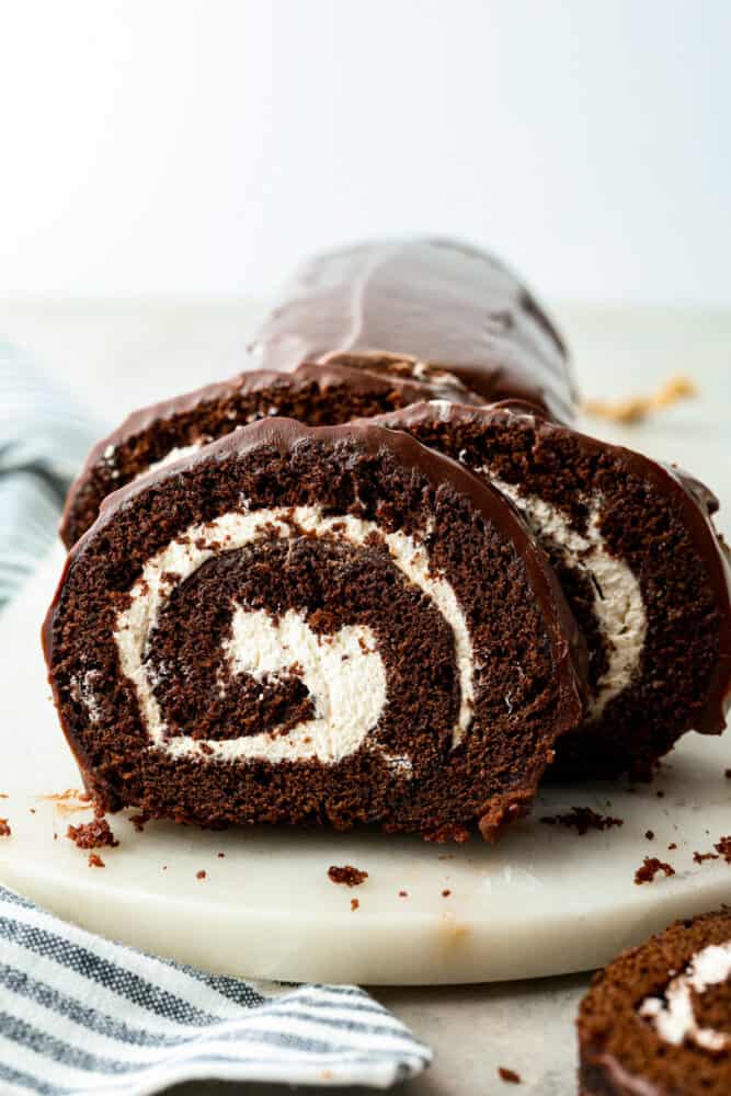 A slice of swiss roll cake on a plate.