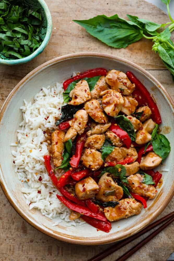 Thai basil chicken on a white plate.