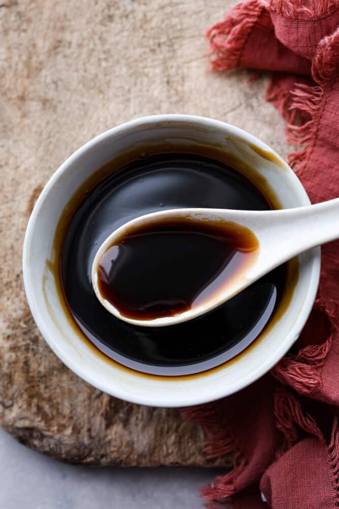 An overhead view of eel sauce in a bowl with a spoon.