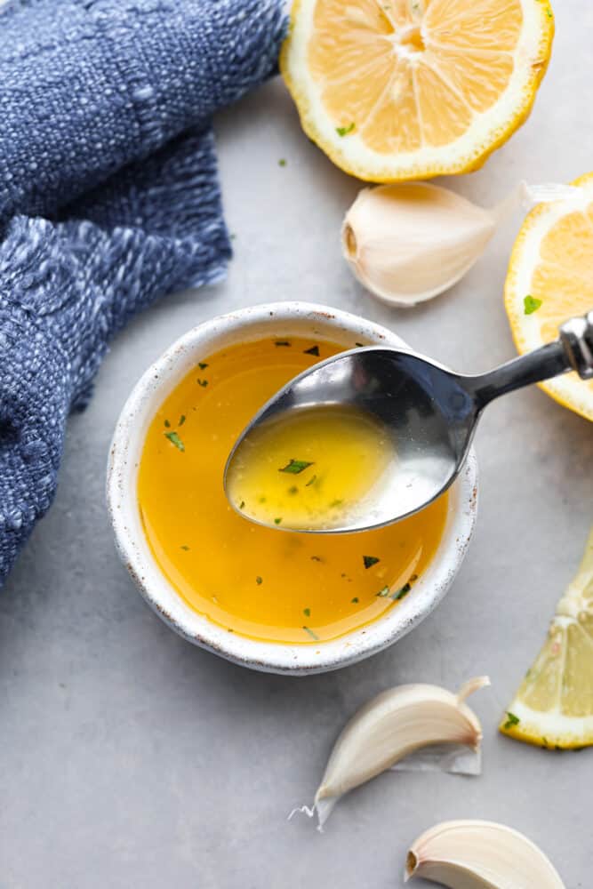 Garlic butter sauce in a small white bowl.