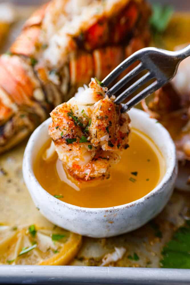 Dipping lobster into the garlic butter sauce.