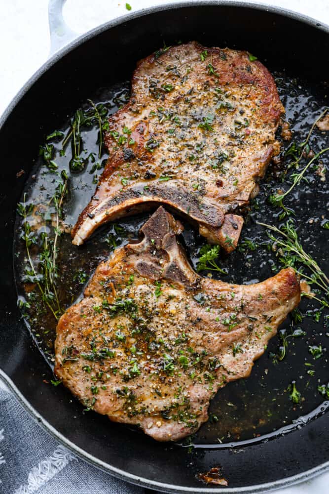 Cast iron skillet pork chops in a cast iron pan.
