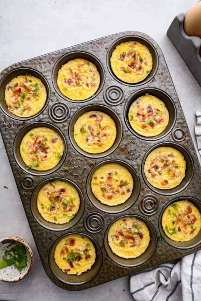 An overhead view of the egg bites in a muffin pan.