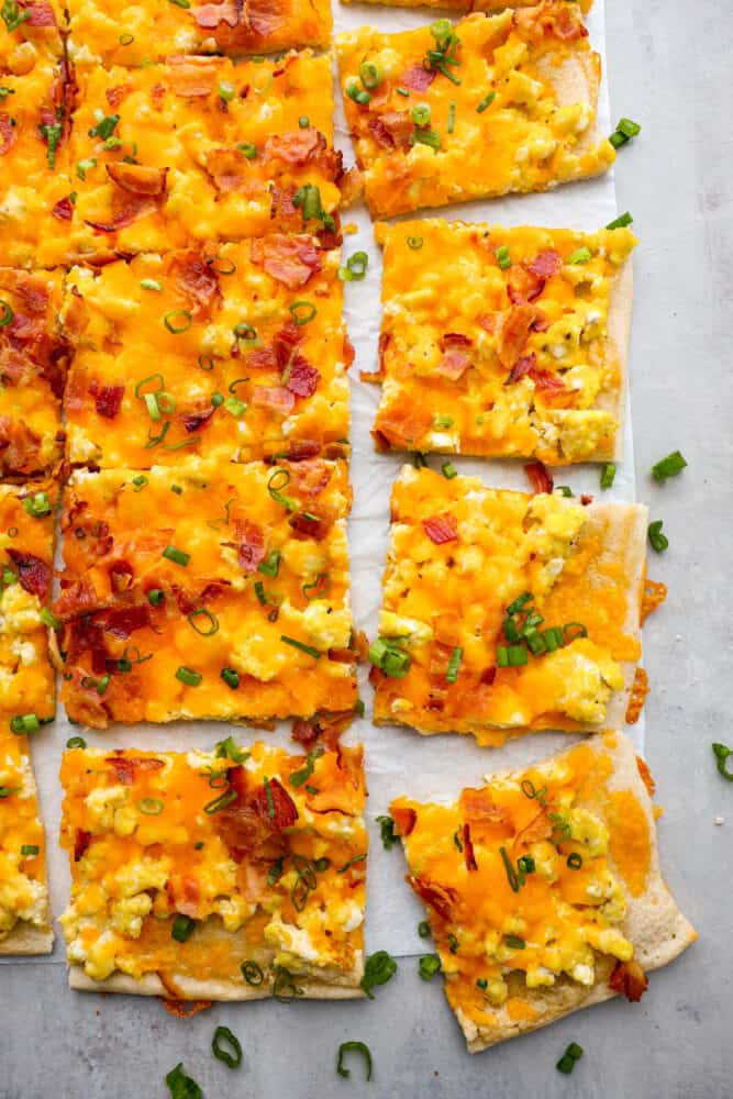 Top-down view of breakfast pizza cut into slices.