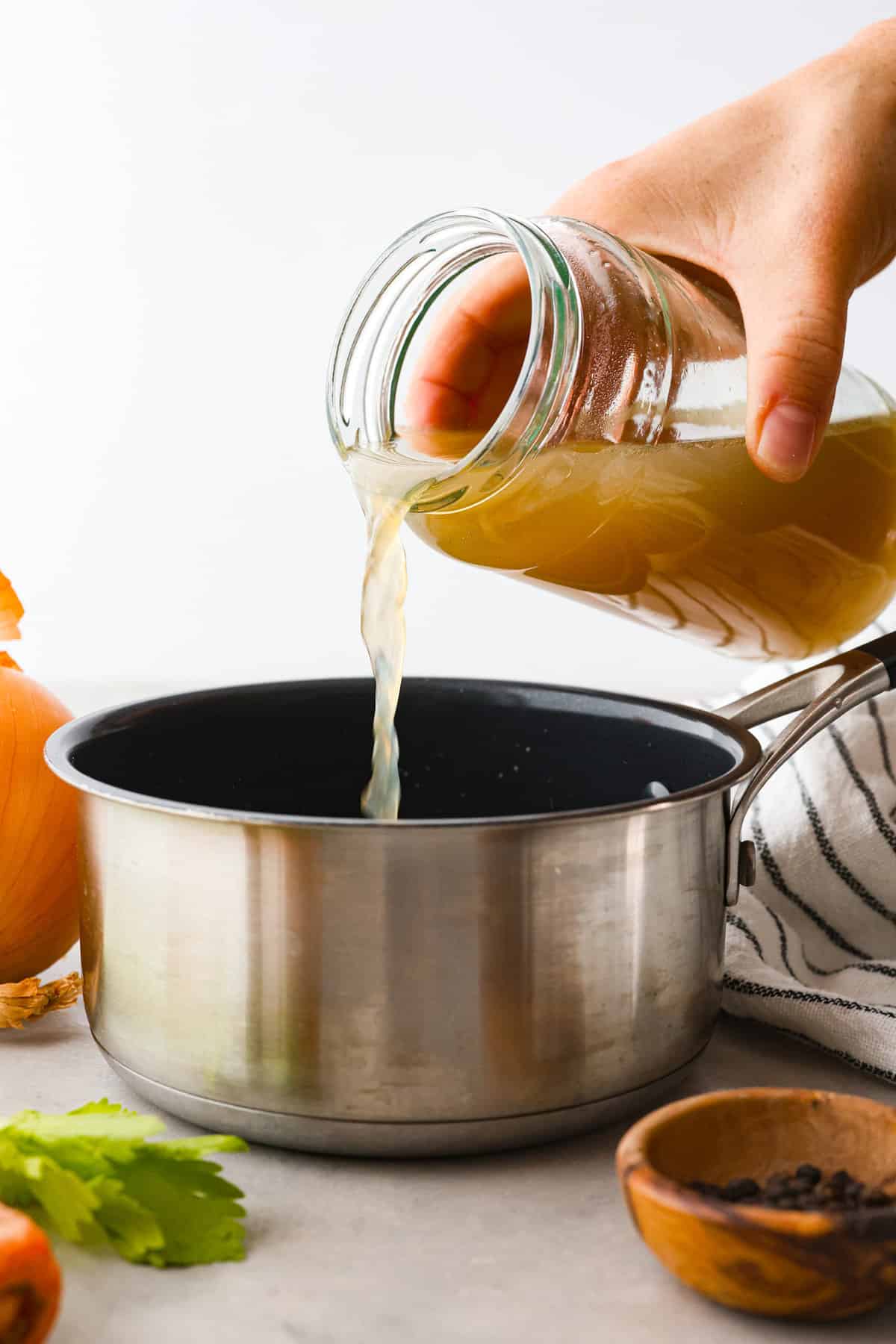 This guide gives you easy swaps that actually work. Save this list and come back to it anytime you need a quick answer! Broth being poured into a pan.