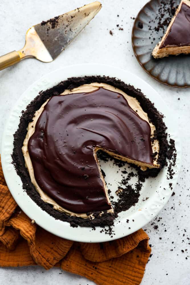 Vista de arriba hacia abajo del pastel de chocolate con mantequilla de maní con una rebanada cortada.