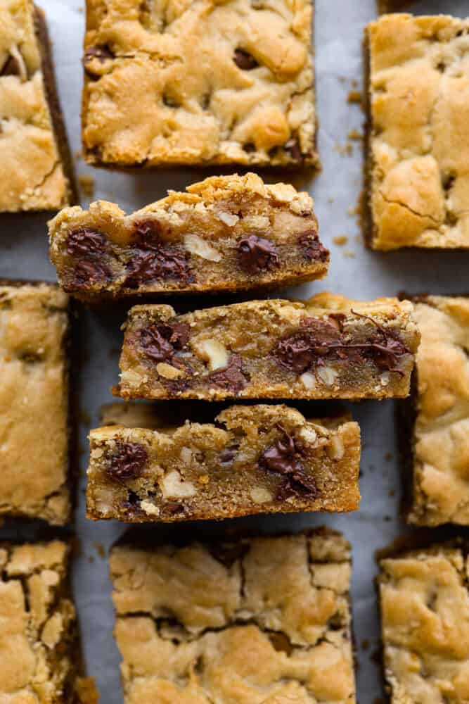 Congo bars are soft and chewy, filled with chocolate chips and walnuts. They’re like a gooey chocolate chip cookie in bar form and will have you savoring every bite! Closeup of congo bars.