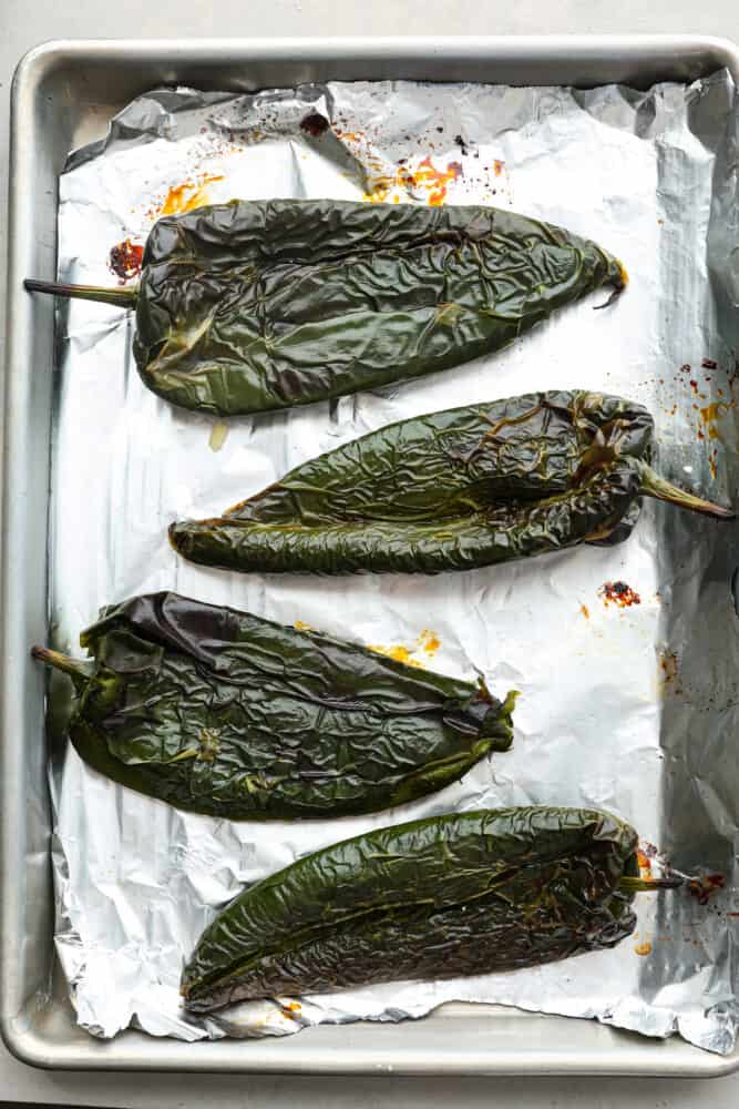 4 poblano peppers after being roasted.