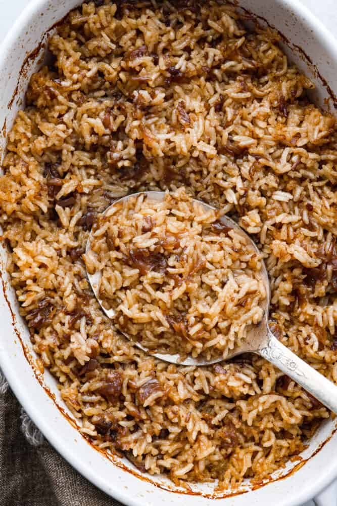 A close up of baked rice in a casserole dish.