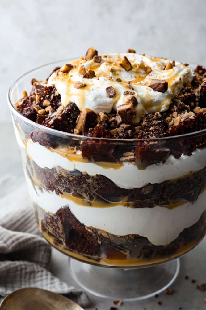 Chocolate cake, whipped cream, caramel, and crushed toffee bits in a trifle dish.
