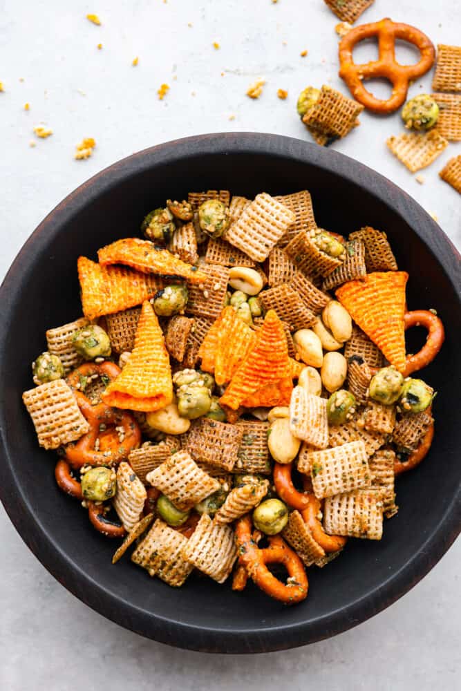 Top-down view of furikake chex mix in a black bowl.