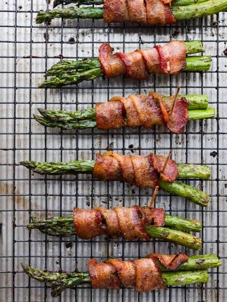 Bacon-wrapped asparagus on a cooling rack.