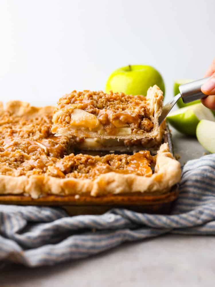 the side view of a slice of caramel apple slab pie being served. 