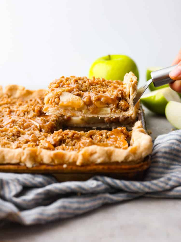 the side view of a slice of caramel world slab pie stuff served. 