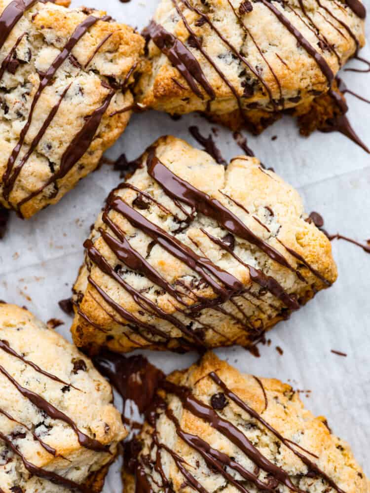 Top-down view of chocolate chip scones, drizzled with melted chocolate.