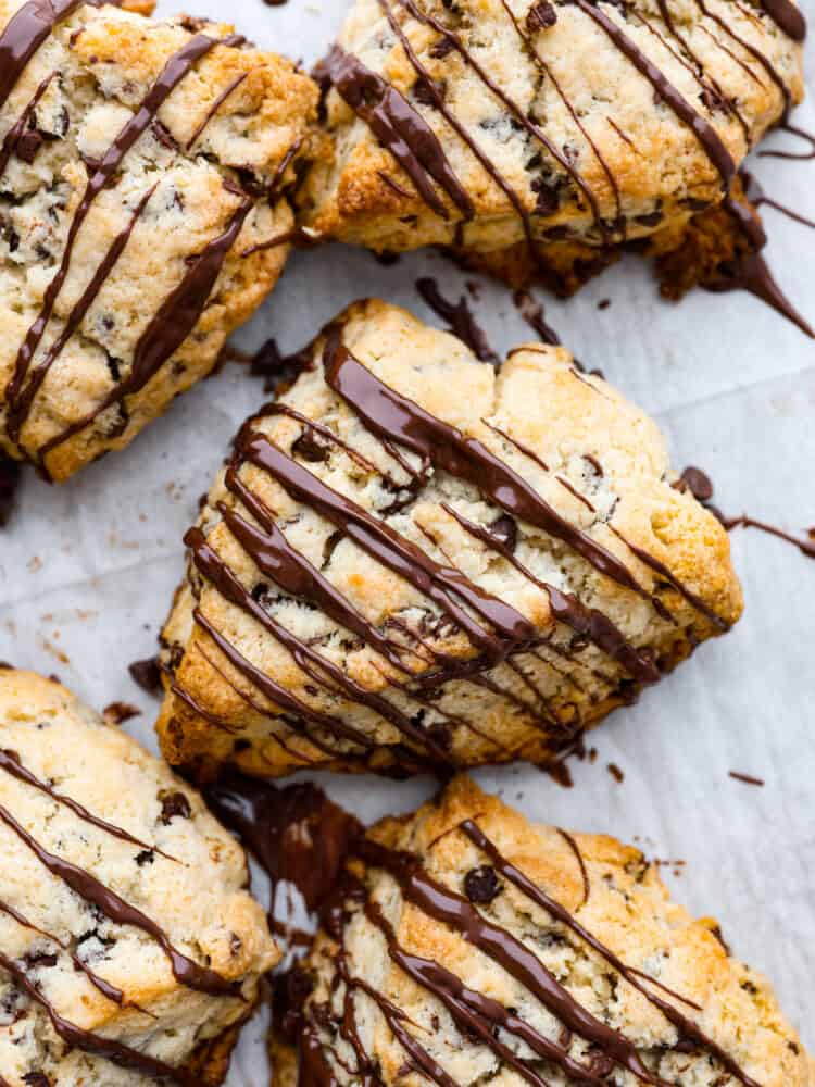 Draufsicht auf Chocolate Chip Scones, beträufelt mit geschmolzener Schokolade.