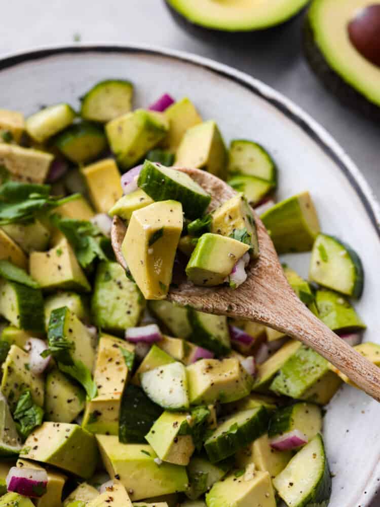 Closeup of a spoonful of cucumber avocado salad.
