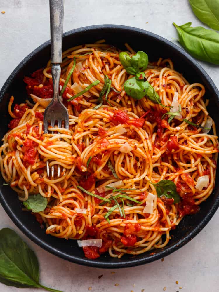 A bowl of pasta pomodoro with a fork in it. 