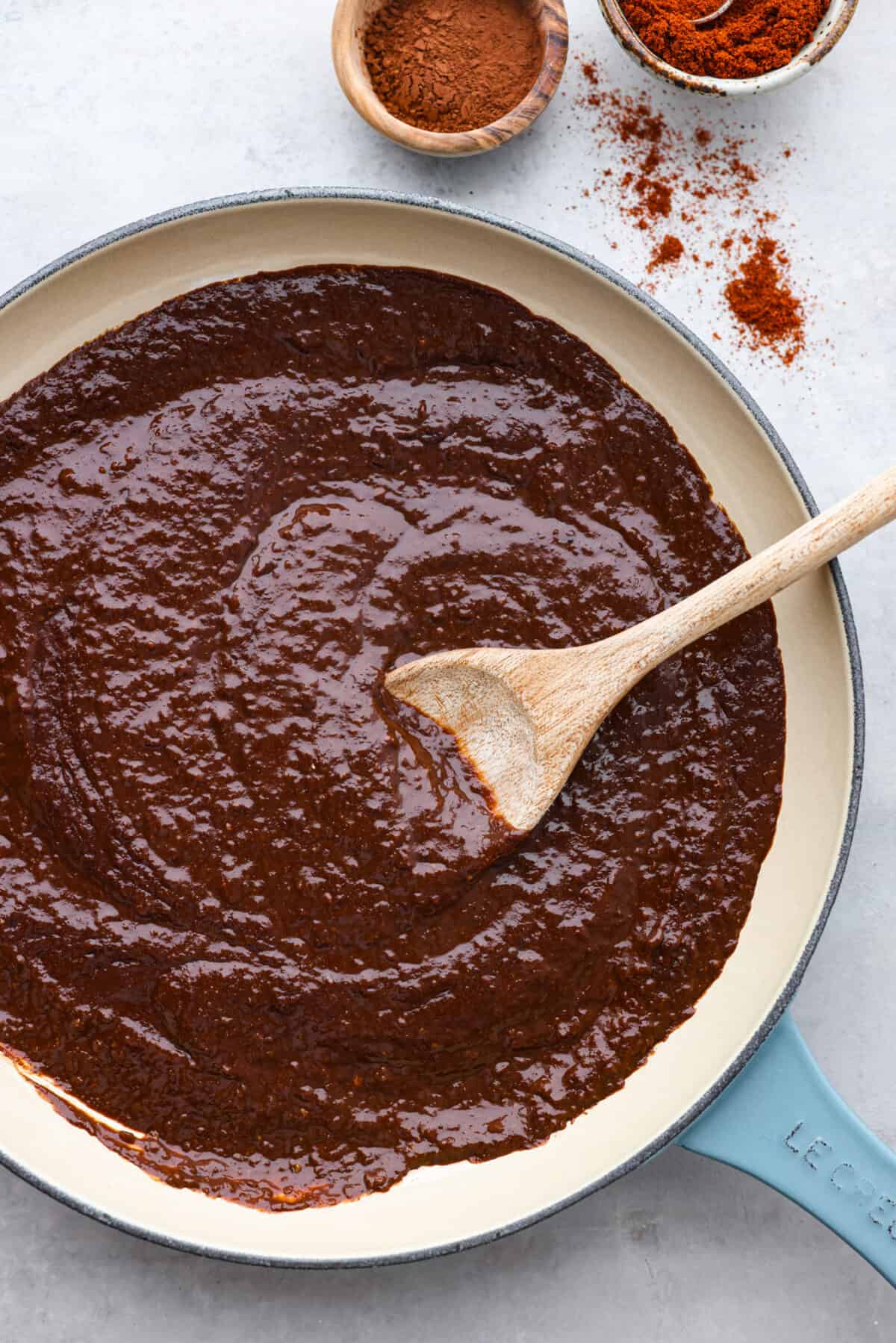 Mole sauce in a blue and white skillet.