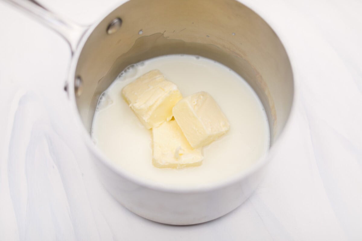 Overhead shot of milk and butter in a saucepan. 