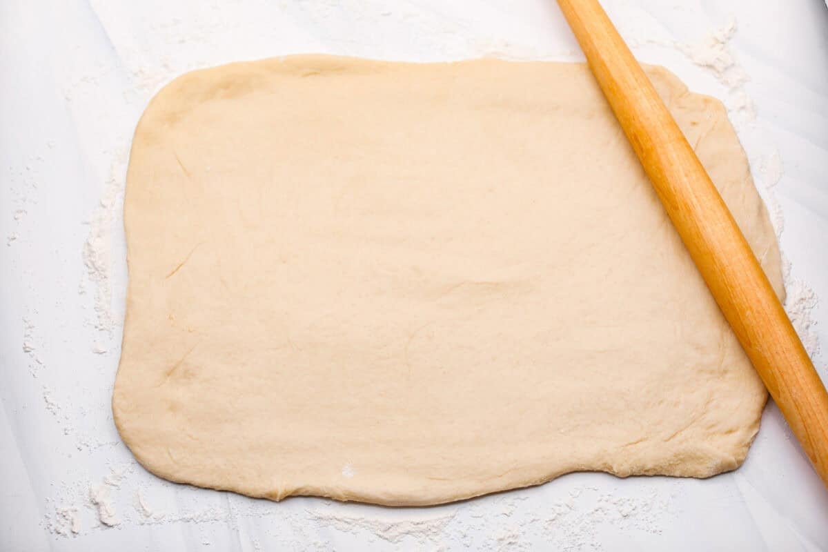 Overhead shot of the dough rolled out onto a floured surface. 