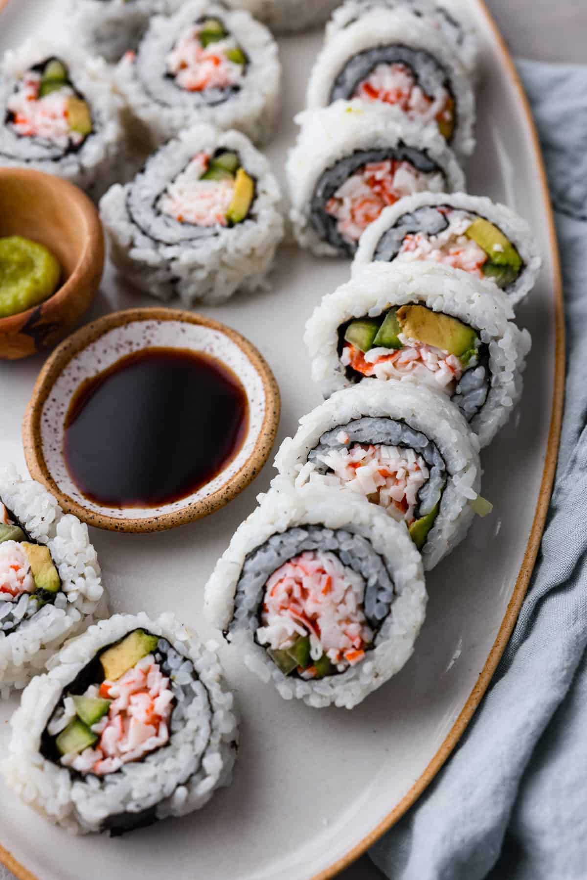 Sushi rolls served with soy sauce in a small bowl.
