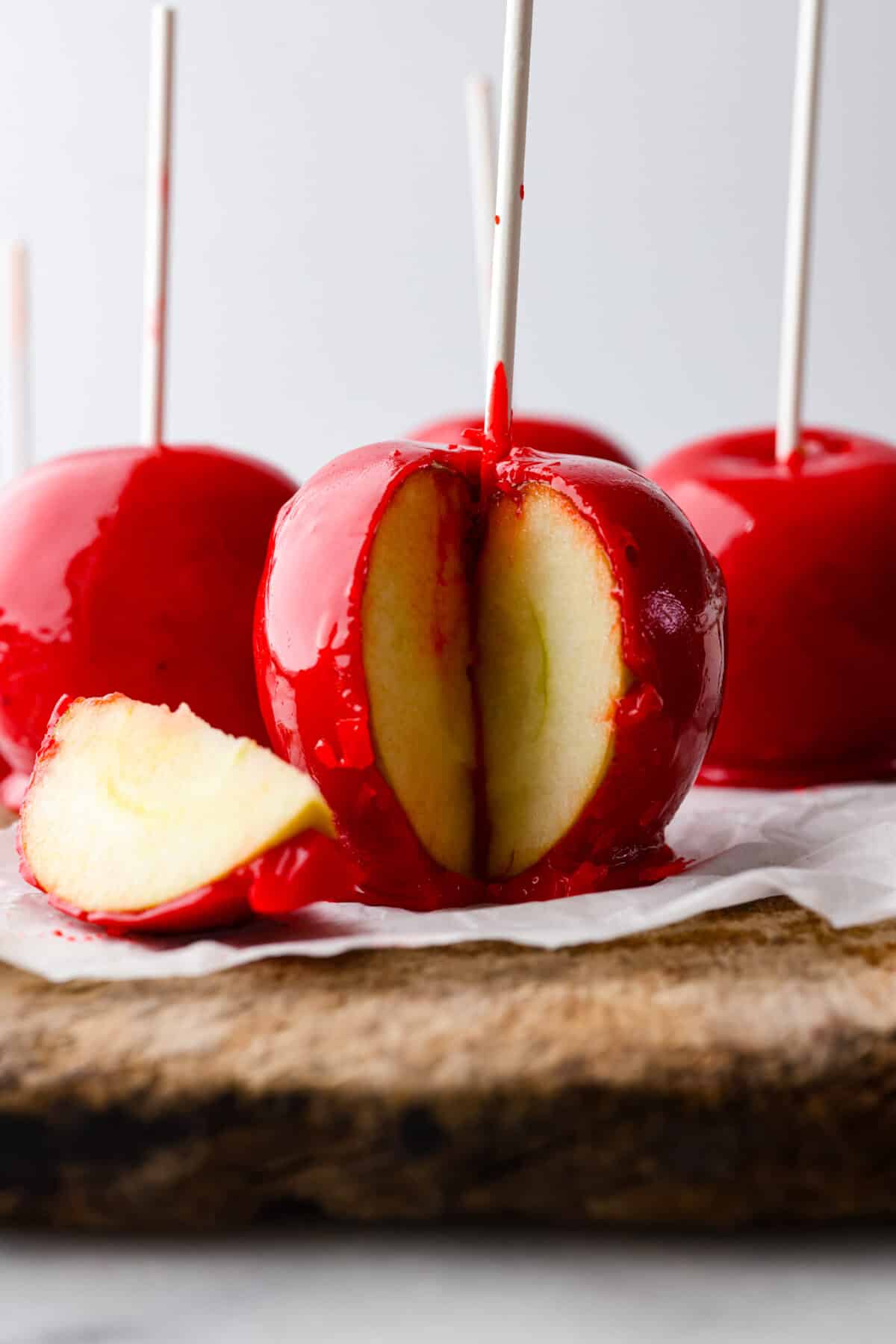 Hero image of candied apples, one has a piece cut out of it.