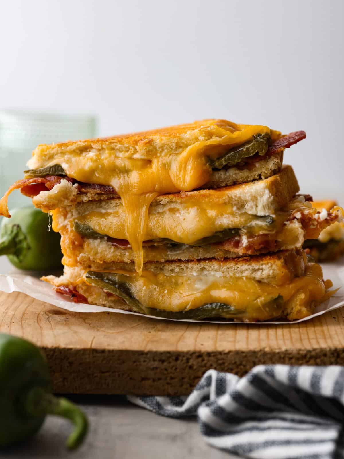 3 slices of jalapeno popper grilled cheeses stacked on top of each other.