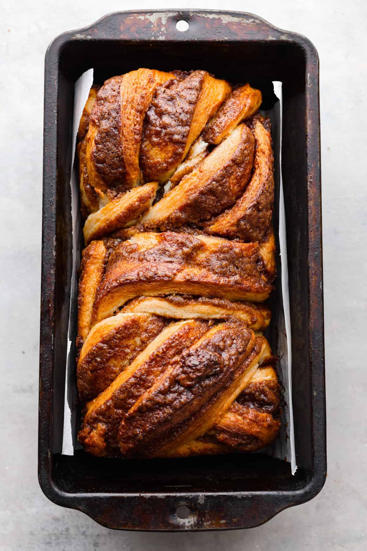 The top view of cinnamon babka baked in a pan. 