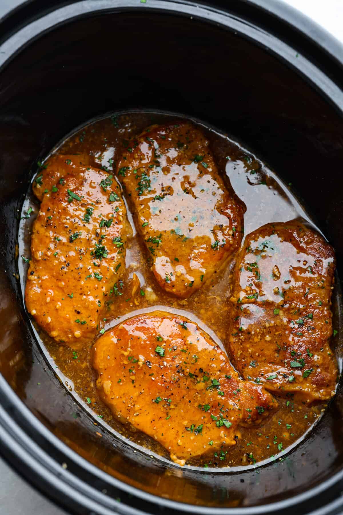 Cooked honey garlic pork chops in the slow cooker.
