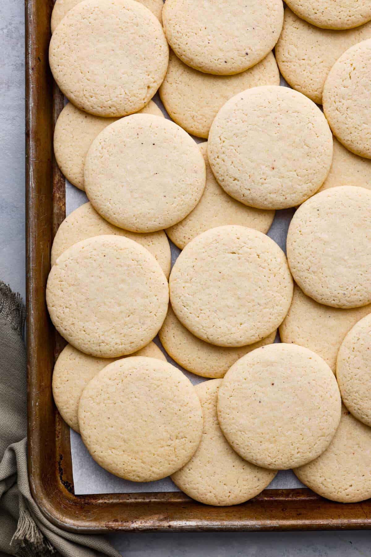 Overhead shot baked tea cakes on cookie sheet.