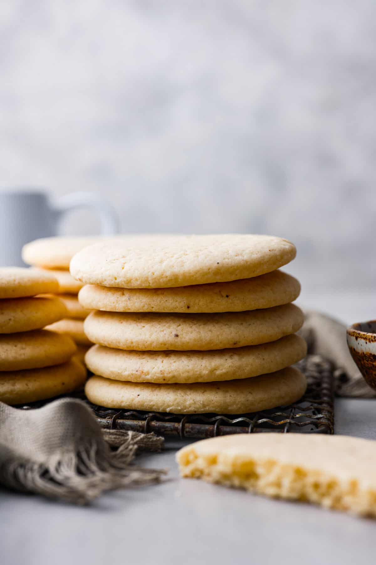 Side shot of a stack of tea cakes on a cooling rack. 