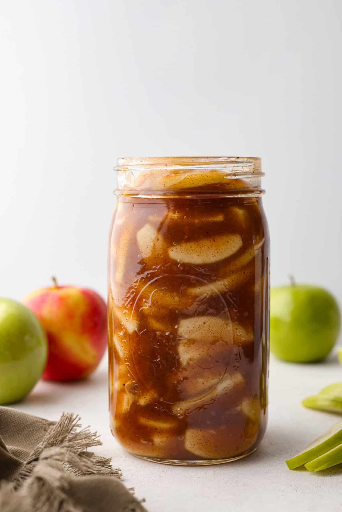 A mason jar filled with apple pie filling.