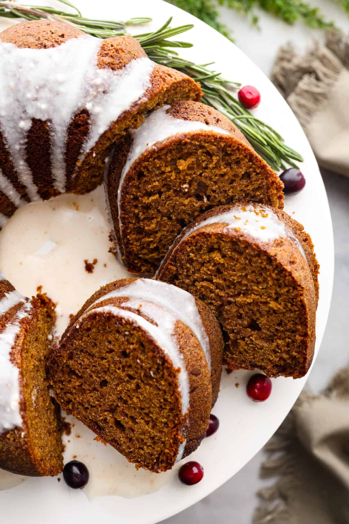 Top-down view of a gingerbread bundt cake, cut into slices.