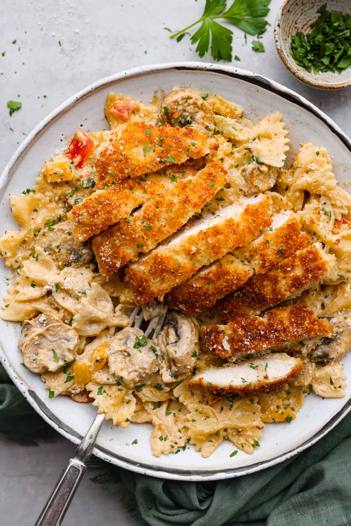 Sliced, breaded chicken served over bow tie pasta with a creamy Cajun sauce.