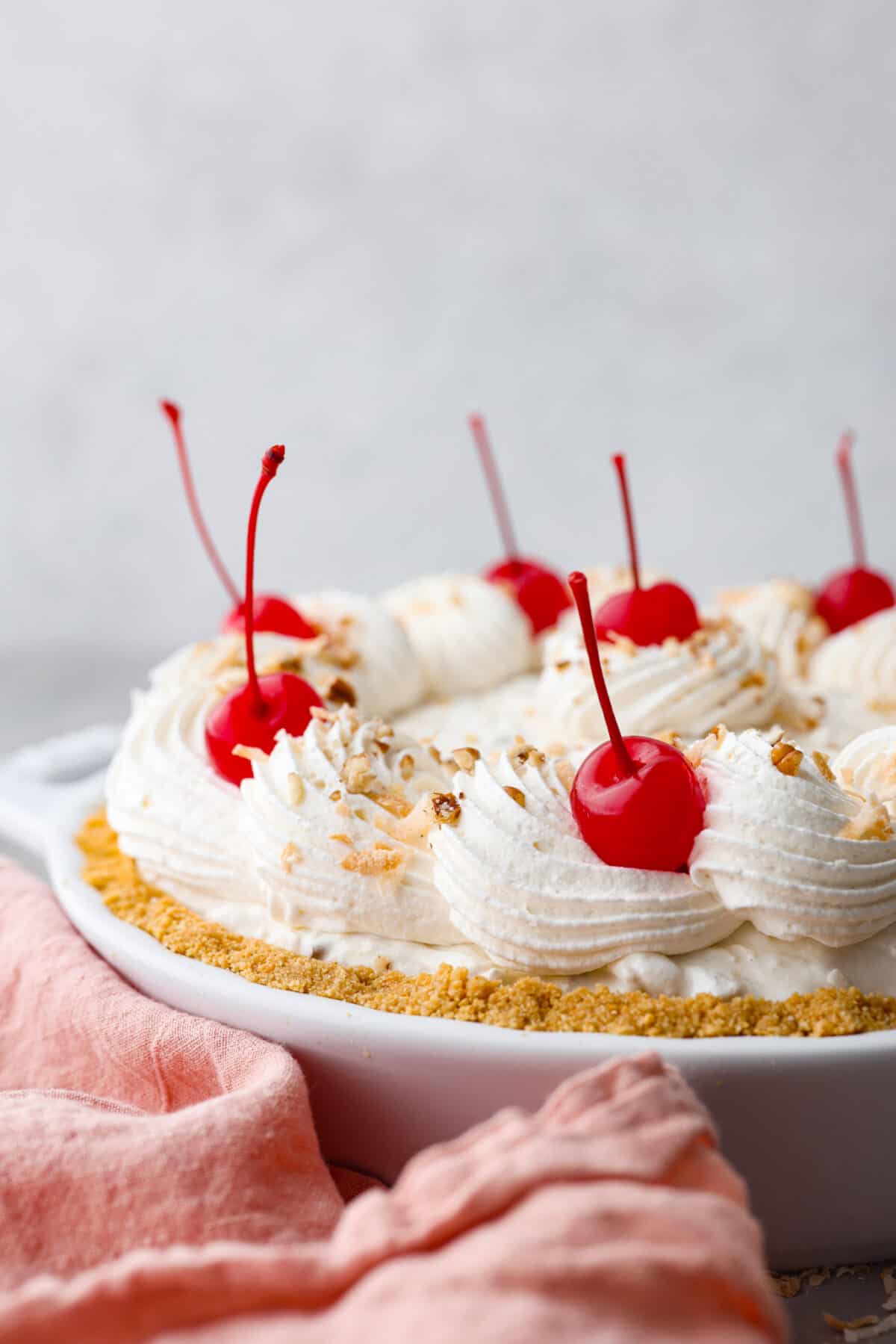A whole million dollar pie, topped with whipped cream and maraschino cherries.