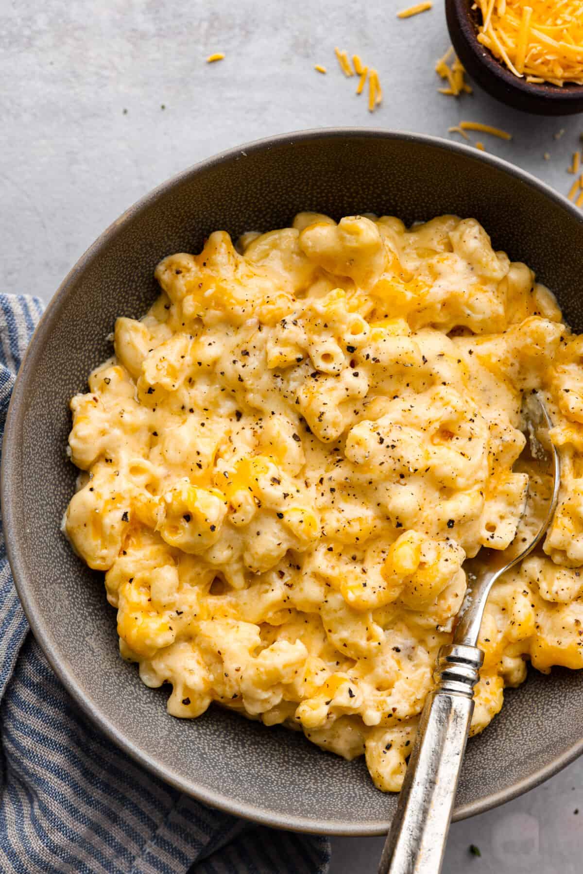 A serving of macaroni and cheese in a gray dish.