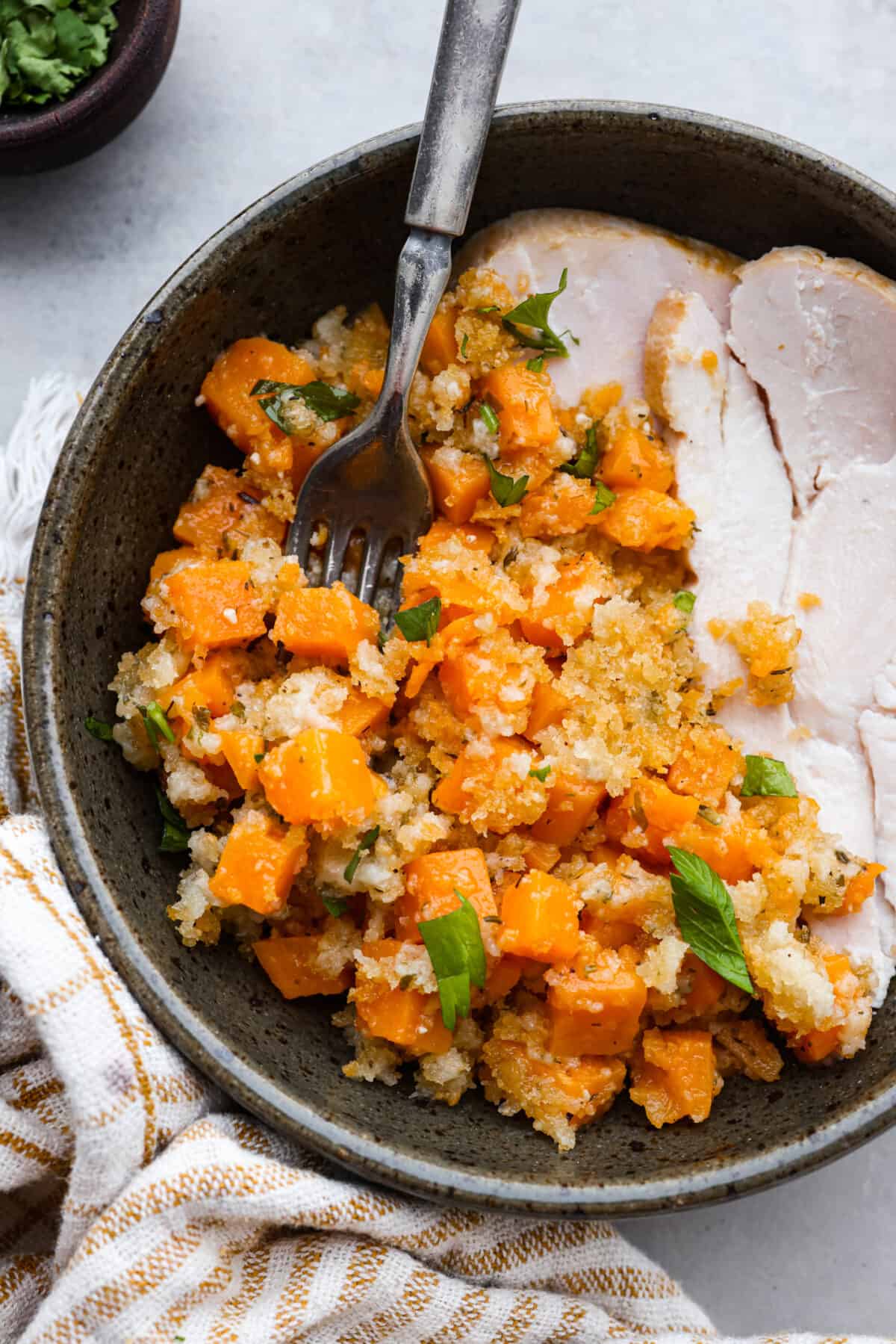 Turkey and sweet potato casserole served in a gray bowl.