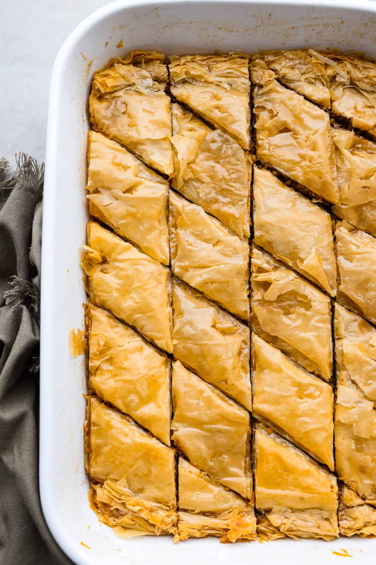 Top-down view of baklava in a white baking dish.