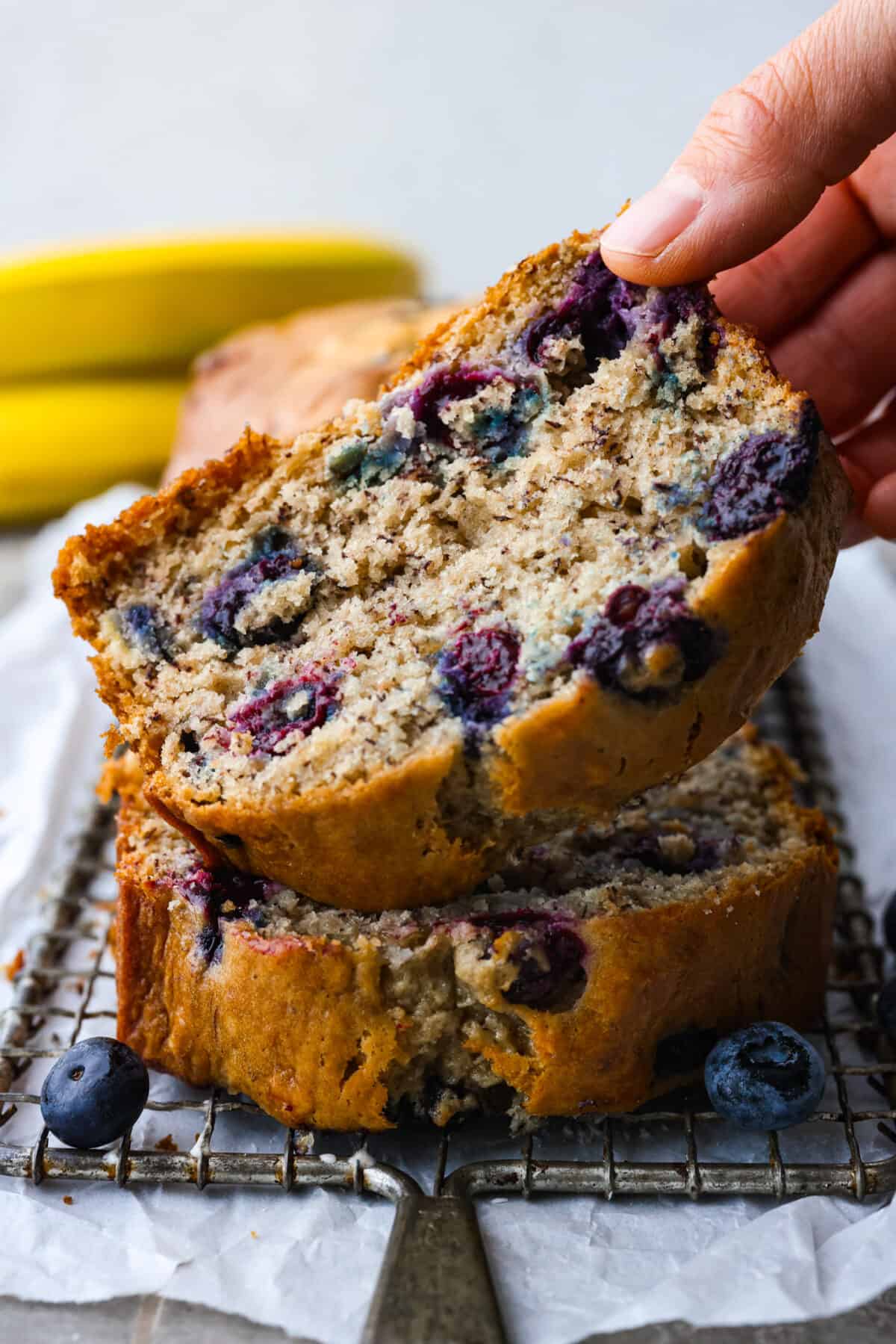 2 slices of blueberry banana bread stacked on top of each other.
