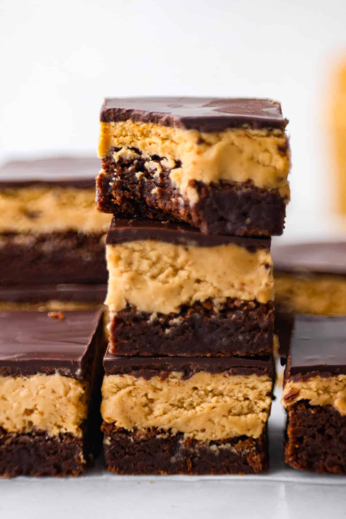 Close view of three stacked brownies with a bite out of the top brownie.