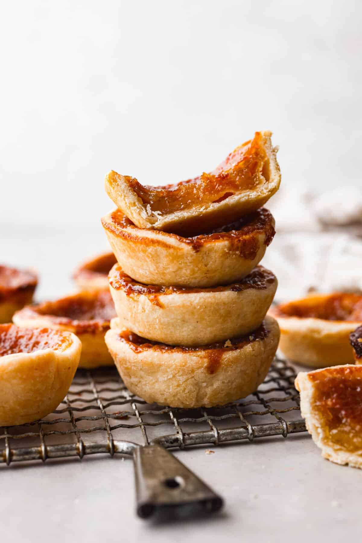 4 tarts stacked on top of each other. One is cut in half so you can see the filling.