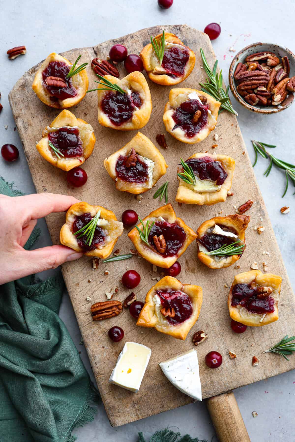 The top view of cranberry brie bites on a wooden platter. 