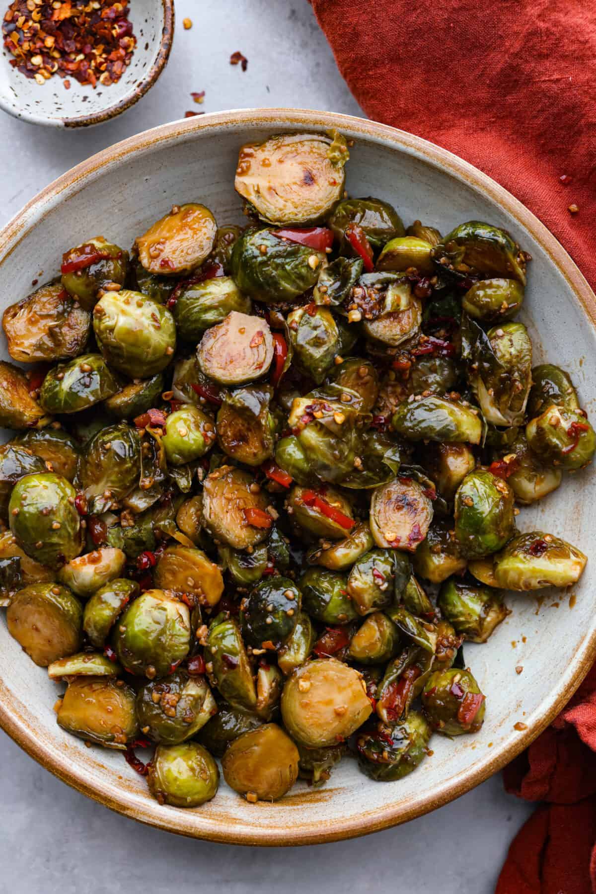 Kung Pao Brussels sprouts in a stoneware bowl.