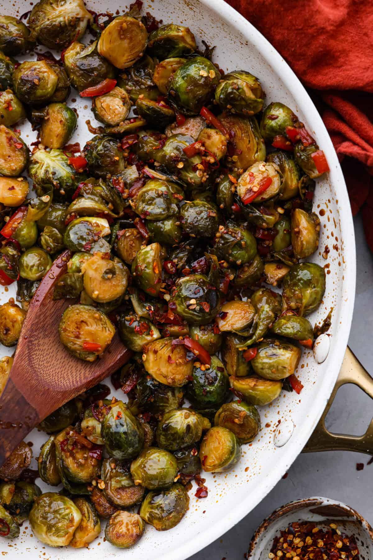 Kung Pao Brussels Sprouts in a white skillet.