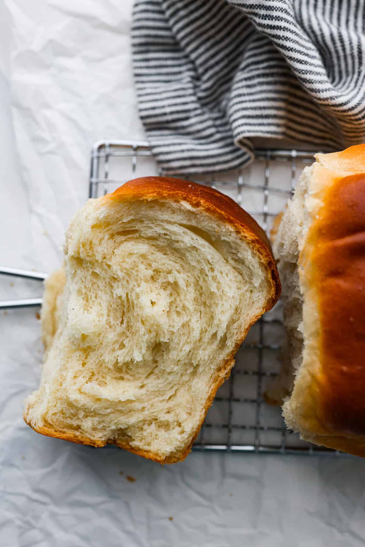 The softest, fluffiest, most delicious bread you'll ever have! Japanese milk bread is a game-changer and will have you in love at first bite. A slice of Japanese milk bread.