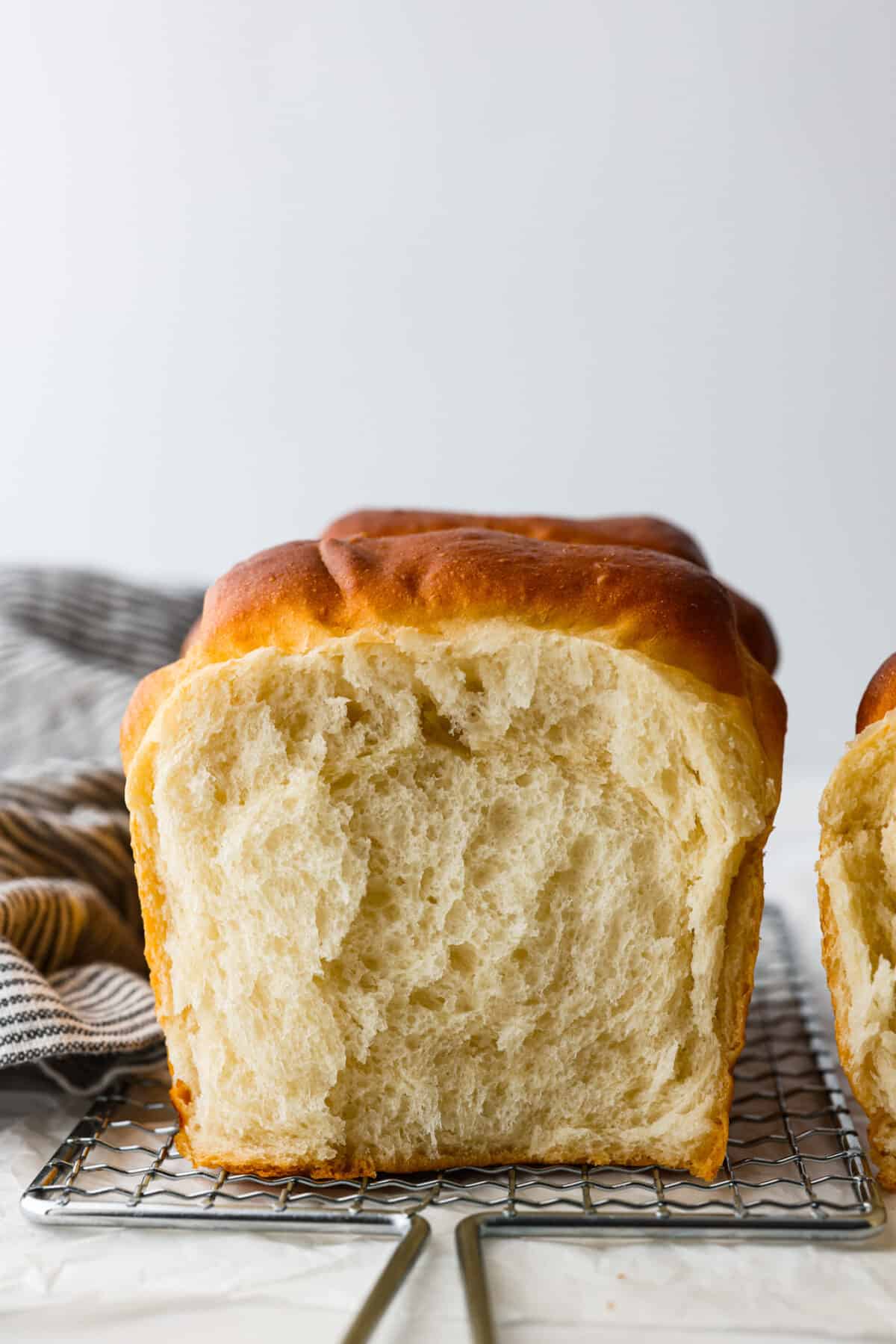 Front view of a loaf of Japanese milk bread on a wire rack.