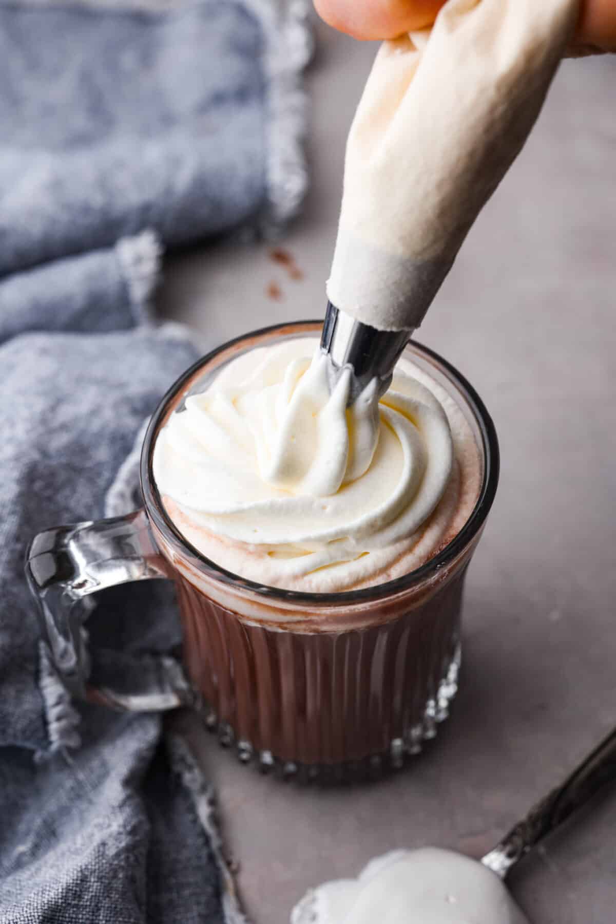 Adding a dollop of marshmallow cream to hot chocolate.
